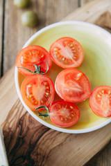 Halves of tomatoes when preparing a dish. Cherry tomatoes cut on a plate.