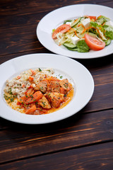 meat with barley and salad on the wooden background