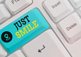 Conceptual hand writing showing Just Smile. Concept meaning assume a facial expression indicating...