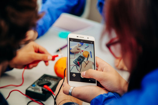 Russia, Krasnodar Territory - November 29, 2018. Children of a scientific shift in a camp are studying electromechanics and rent a process of work on a smartphone. children learn electricity