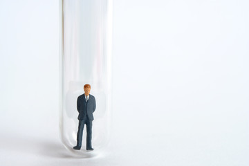 Obraz premium Health conceptual miniature people photography – testing specimen, a volunteer on a laboratory test tube to find a corona virus vaccine 