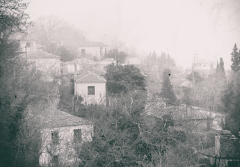 Fog above traditional houses in Milies village on mountain Pelion.Greece. Vintage picture