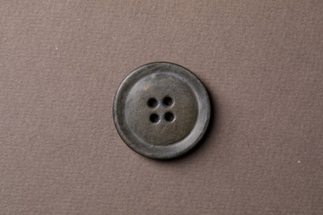  antique button on the brown background