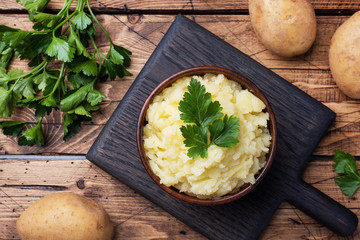 Homemade cream mashed potatoes in a dish with parsley.