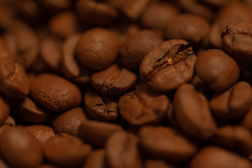 close-up of the texture of roasted coffee beans ready to grind and to prepare a fress coffee drink
