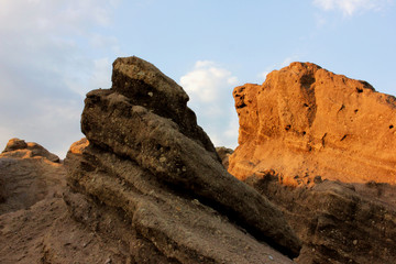 Red rocks and blue sky. Landscape after coal mining from waste heaps. Consequences of opencast coal mining. Terricone on blue sky and white clouds background