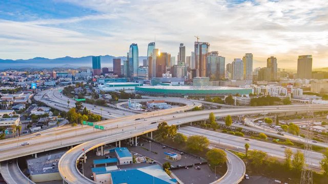 Urban aerial time lapse of downtown Los Angeles California USA skyscraper buildings, convention center, freeway and streets on a sunny morning with beautiful light.