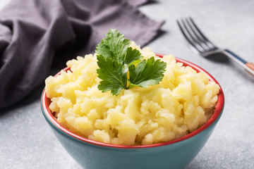 Homemade cream mashed potatoes in a dish with parsley.