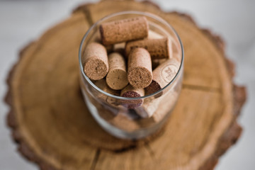 Wine corks lie in a glass jar