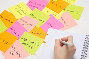 The hand writes on a white page in the daily planner.Student, study, synopsis. Affirmations,...