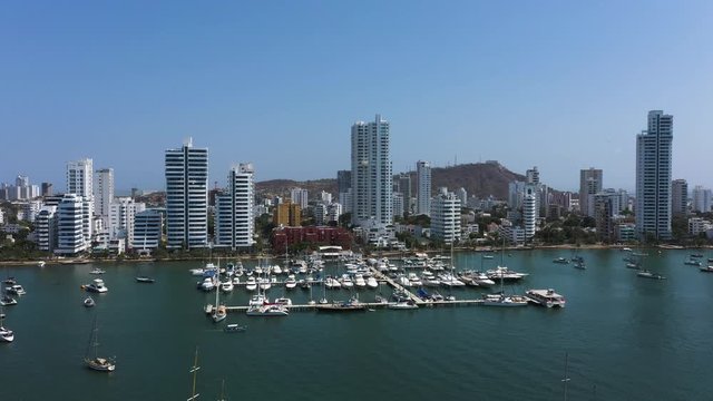 Aerial view of a yacht club in a beautiful bay in Cartagena, Colombia. Camera movement from left to right.