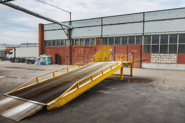 Metal ramp for cargo transfer from  car to  car and unloading on a warehouse.