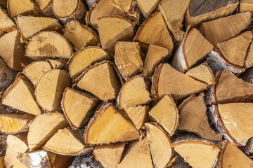 Firewood stack for the background. A lot of cutted logs. Stack of sawn logs. Natural wooden decor...