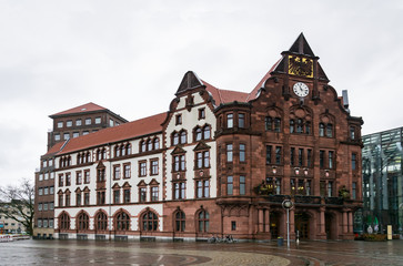 Fototapeta na wymiar The Old Town Hall of Dortmund. The building is located on Friedensplatz. Cloudy, rainy weather. No people in a virus