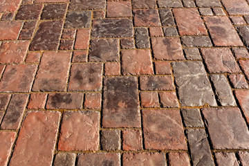 Vintage vertical background pavement made of natural stone of square shape. The sidewalk in the future.