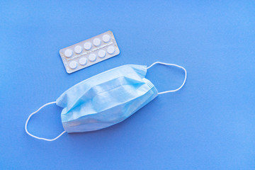 Aspirin in a blister medical dressing.  Vitamin C pills in a pack. White tablets in a blister on a blue background close-up with soft focus.