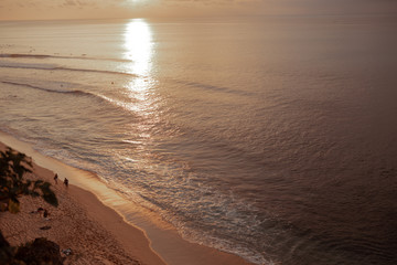 Waves and clouds. Blue ocean Beautiful sunset at Balangan Beach on the island of Bali in Indonesia. Surfers catch the waves, tourists relax and enjoy the sunset or sunrise