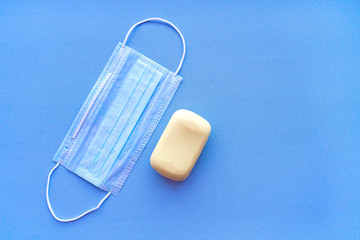 Medical bandage and a piece of hand soap top view on a blue background. Soft focus. A set of main things in a coronavirus epidemic.