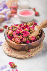 Spa and wellness concept with  dry roses, pink oil and creame on concrete  background.