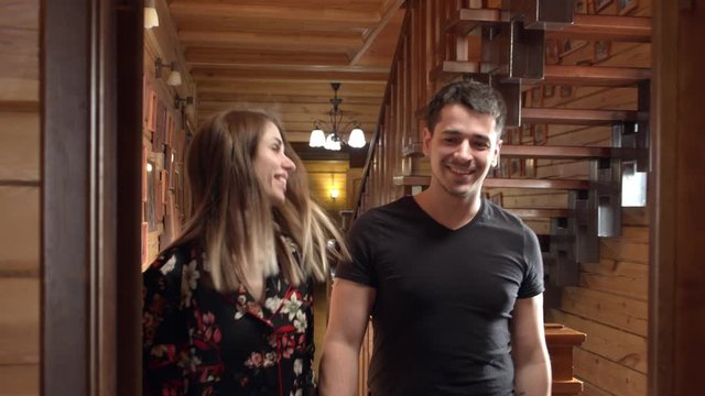 couple checking in wooden hostel in siberia