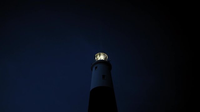 Nightime lighthouse with turning lantern