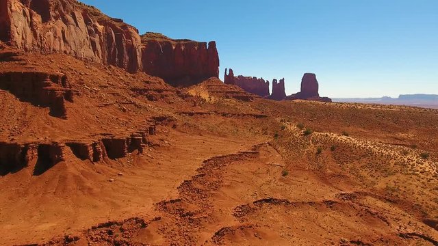 Monument Valley red rock desert Utah Arizona. Monument Valley Arizona Utah drone flying around Red rock climbing buttes towers desert southwest west hot dry sky Navajo nation reservation, plateau mesa