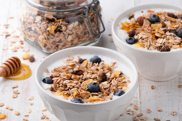 Muesli in a bowl on white wooden background