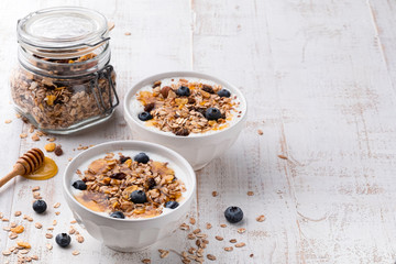 Muesli in a bowl on white wooden background