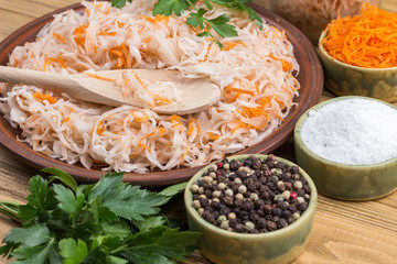Sauerkraut on plate, grated raw carrots,  parsley, salt and spices.