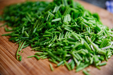 Fresh green chive chopped on wooden table
