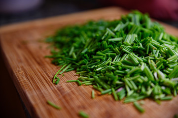 Fresh green chive chopped on wooden table