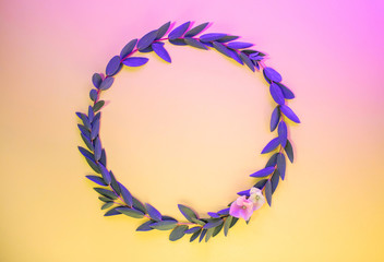 Creative neon background with leaves. Colorful abstract backdrop with frame of plants and space for text. Exotic floral branch with pink and yellow vivid colors. Organic twigs with shiny backlight