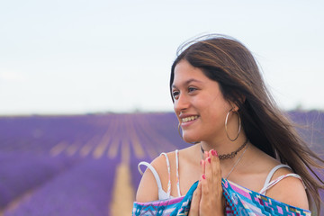 A teenager smiling and happy in a lavender field