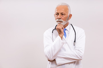 Image of worried  senior doctor thinking on gray background.