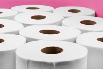 Toilet paper rolls on pink background