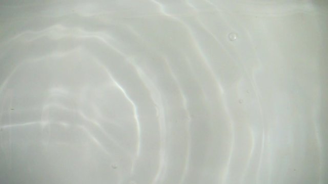 Oranges falling into the water. Slow motion.