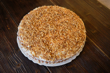 Carrot cake and fresh carrot on wooden table
