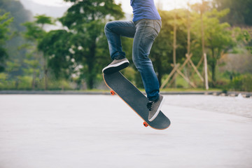 Skateboarder legs skateboarding at park