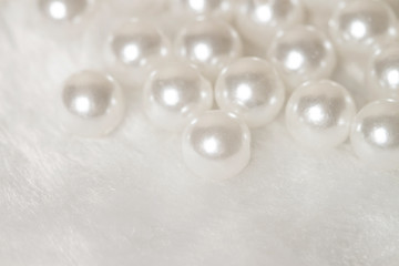 Bunch white shiny pearls with soft light fur