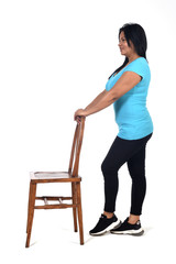 Fototapeta na wymiar woman playing with a chair in white background, profile