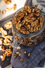  A handful of walnuts in a glass jar. Food photo for grocery stores, healthy snack, vegetarian food.