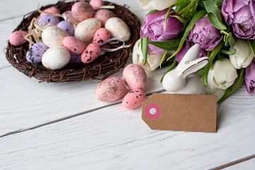 Easter eggs and tulips flowrer on a wooden background. Image