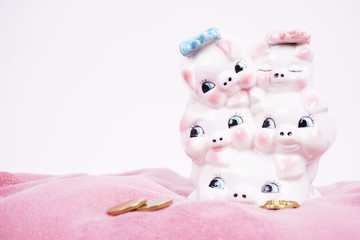 Ceramic piggy bank piggy for money. A symbol of the availability of money and savings. Photographed on a pink soft background.