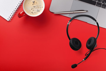 Office red workplace with coffee cup and headset
