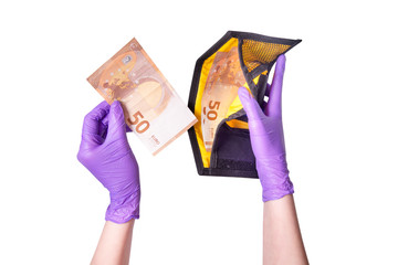 Hands in gloves holding wallet with euro banknotes