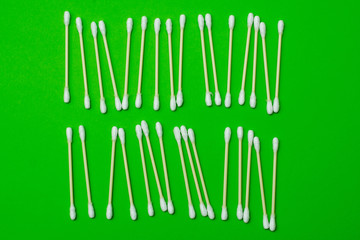 ear buds laid out on a green background. business concept.