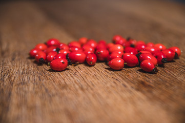 Dark red rose hip on basket