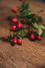 Dark red rose hip on basket