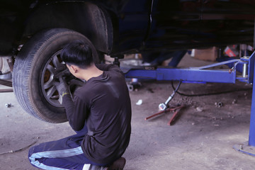 The mechanic is checking the engine.