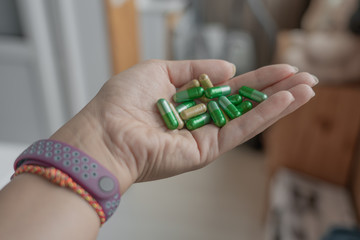 Handful of green pills in the palm 